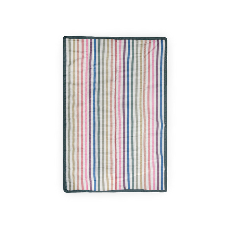 Little Unicorn’s Chroma Rugby Stripe outdoor throw blanket, ideal for picnics, beach trips, and backyard adventures.