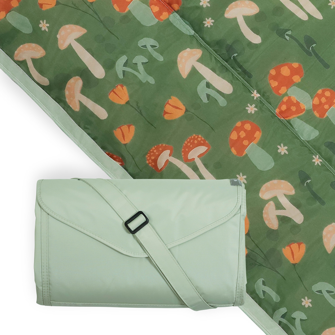 Little Unicorn Outdoor Blanket - Woodland Mushroom spread on grass, perfect outdoor blanket for family picnics.
