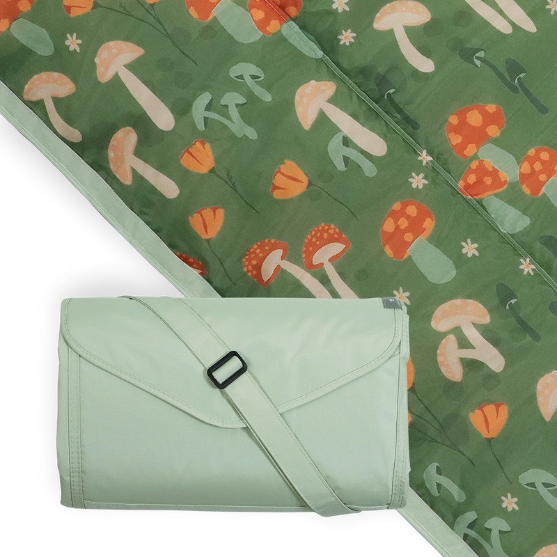 Little Unicorn Outdoor Blanket - Woodland Mushroom spread on grass, perfect outdoor blanket for family picnics.