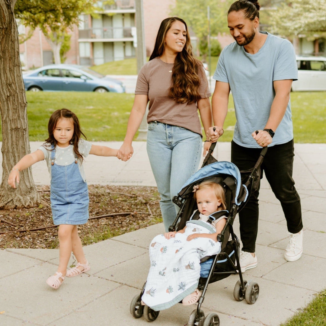 Lifestyle image showing the Little Unicorn Cotton Muslin Baby Quilt - Prickle Pots in use, a lightweight muslin baby blanket essential.