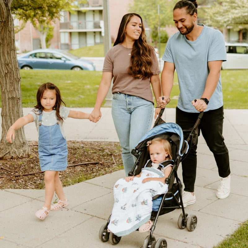 Lifestyle image showing the Little Unicorn Cotton Muslin Baby Quilt - Prickle Pots in use, a lightweight muslin baby blanket essential.