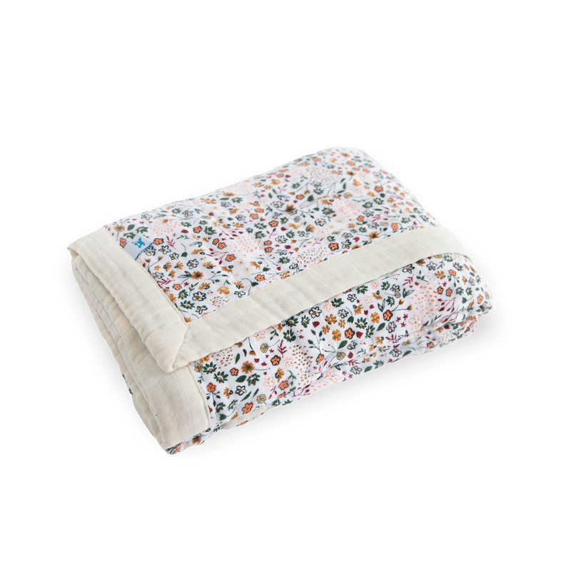 Close-up of Little Unicorn Cotton Muslin Baby Quilt - Pressed Petals highlighting breathable layers of premium muslin for baby comfort.