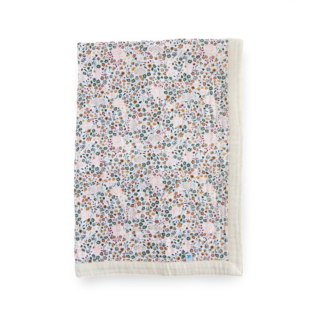 Little Unicorn Cotton Muslin Baby Quilt - Pressed Petals shown in a soft floral design, the perfect cozy baby blanket for every season.