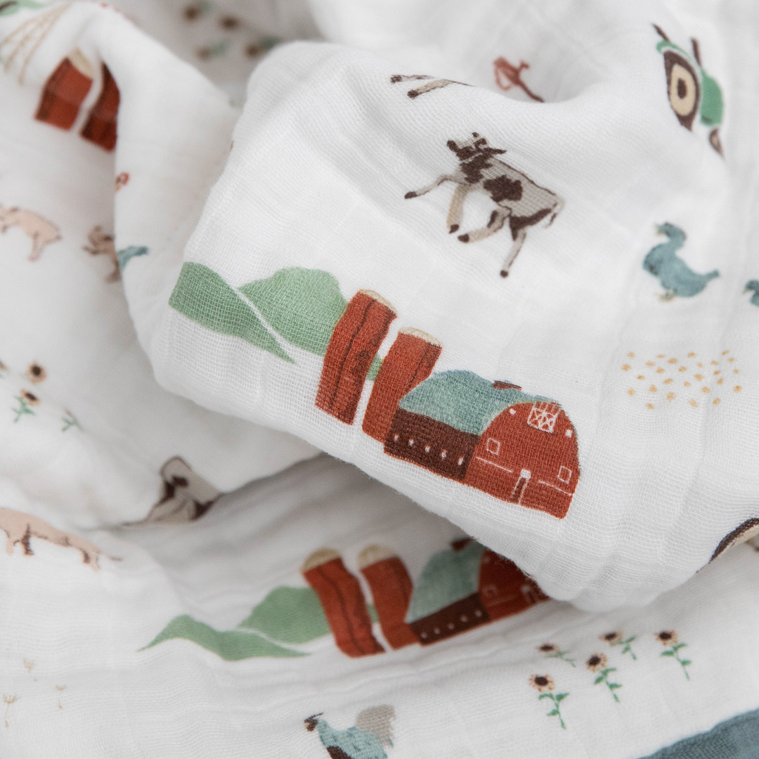 Little Unicorn Cotton Muslin Baby Quilt - Farmyard displayed folded, showcasing charming animal details and quality muslin craftsmanship.