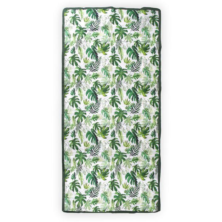 Little Unicorn’s Tropical Leaf waterproof outdoor blanket, lightweight and durable for outdoor adventures.