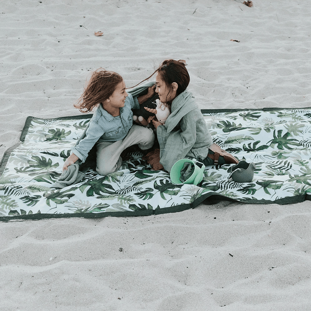 Compact Tropical Leaf Outdoor Blanket by Little Unicorn, foldable and soft outdoor throw blanket perfect for park days.