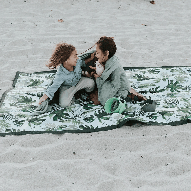 Compact Tropical Leaf Outdoor Blanket by Little Unicorn, foldable and soft outdoor throw blanket perfect for park days.
