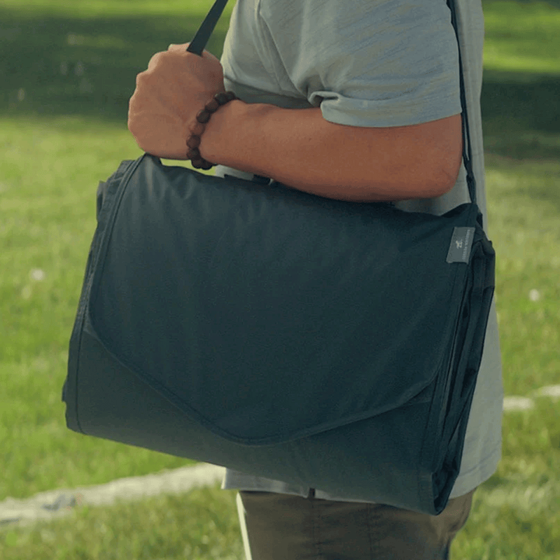 Little Unicorn Outdoor Blanket - Chroma Rugby Stripe draped for playtime, soft and durable outdoor blankets made for comfort.