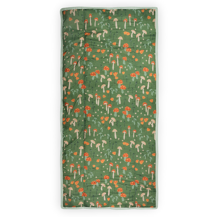 Little Unicorn’s Woodland Mushroom waterproof outdoor blanket, ideal for camping or beach outings.