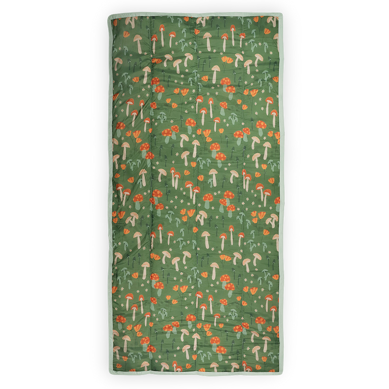 Little Unicorn’s Woodland Mushroom waterproof outdoor blanket, ideal for camping or beach outings.