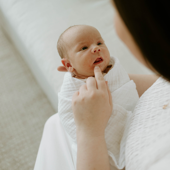 White muslin baby blankets from Little Unicorn, cozy Organic Cotton Muslin Swaddle Blanket.