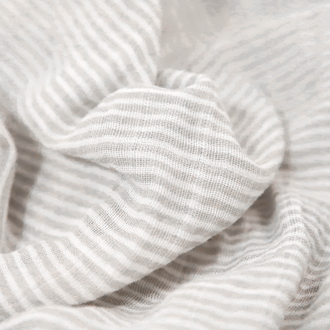 Wrap your little one in comfort with Little Unicorn Sand Stripe Muslin Swaddle, perfect muslin blankets.