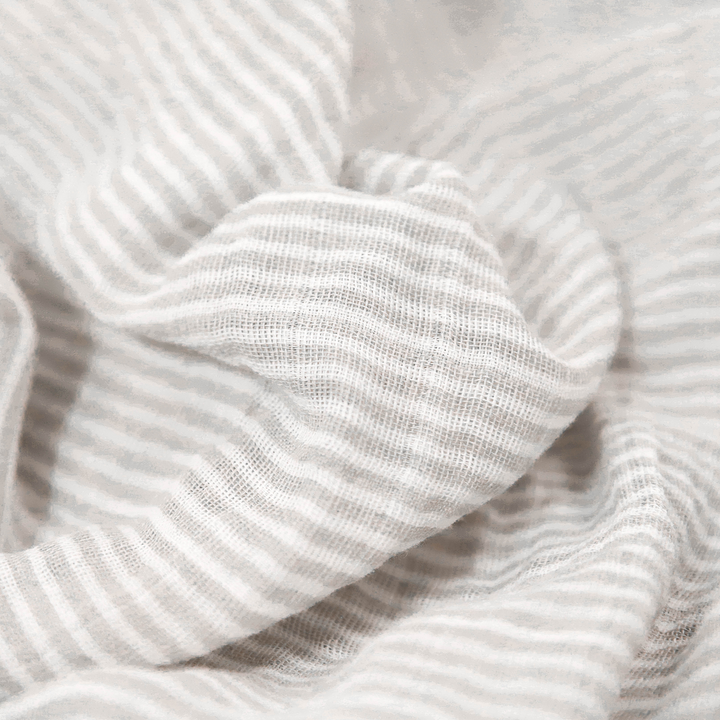 Wrap your little one in comfort with Little Unicorn Sand Stripe Muslin Swaddle, perfect muslin blankets.
