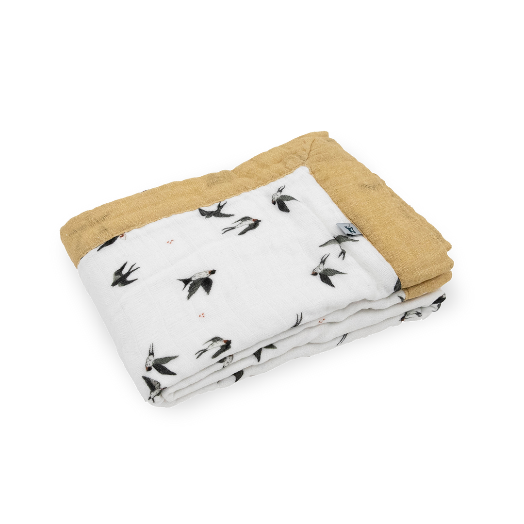 The Little Unicorn Organic Cotton Muslin Baby Quilt - Swallows displayed in full, a breathable muslin blanket perfect for nurseries.