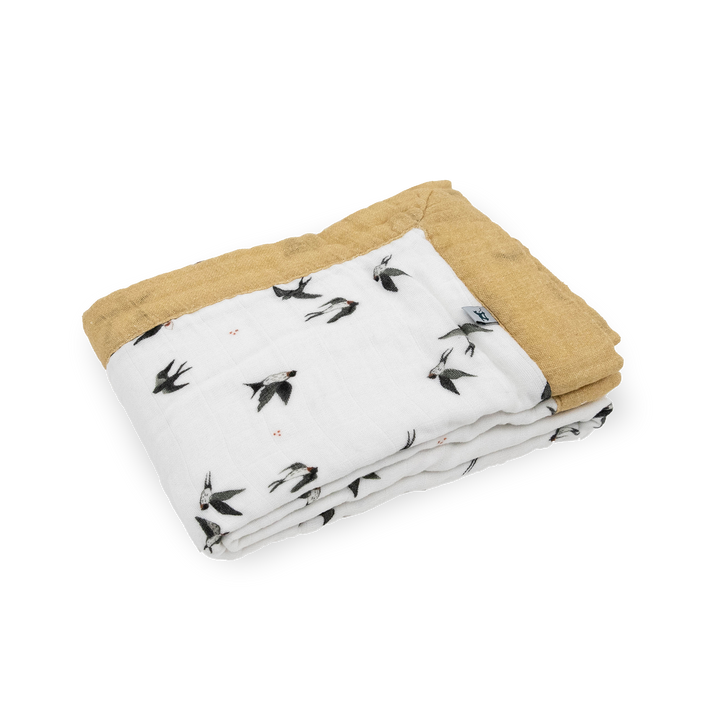 The Little Unicorn Organic Cotton Muslin Baby Quilt - Swallows displayed in full, a breathable muslin blanket perfect for nurseries.