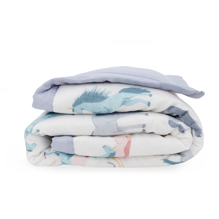 Flat lay of Little Unicorn Cotton Muslin Toddler Comforter - Unicorns, muslin blankets perfect for toddlers.
