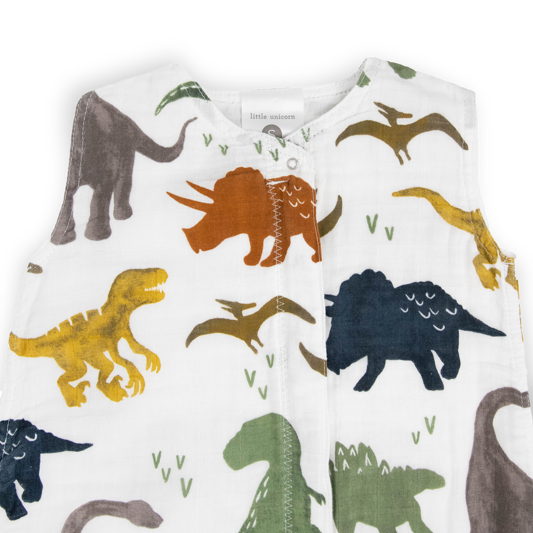 Soft and breathable, the Little Unicorn Cotton Muslin Sleep Bag - Dino Friends makes an ideal infant sleeping bag.