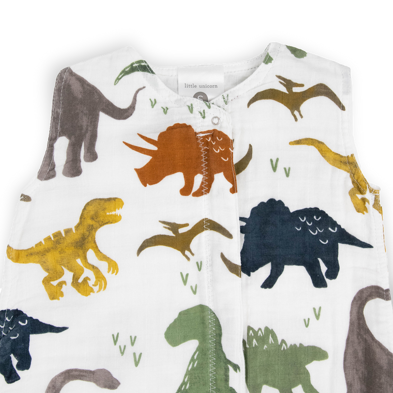 Soft and breathable, the Little Unicorn Cotton Muslin Sleep Bag - Dino Friends makes an ideal infant sleeping bag.