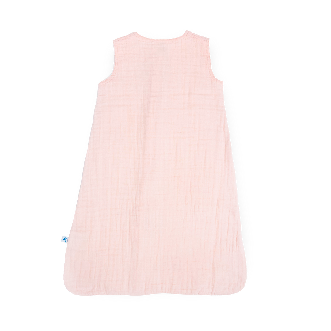 Flat lay of Little Unicorn Cotton Muslin Toddler Comforter - Light Pink, breathable sleep bags for babies with pastel design.