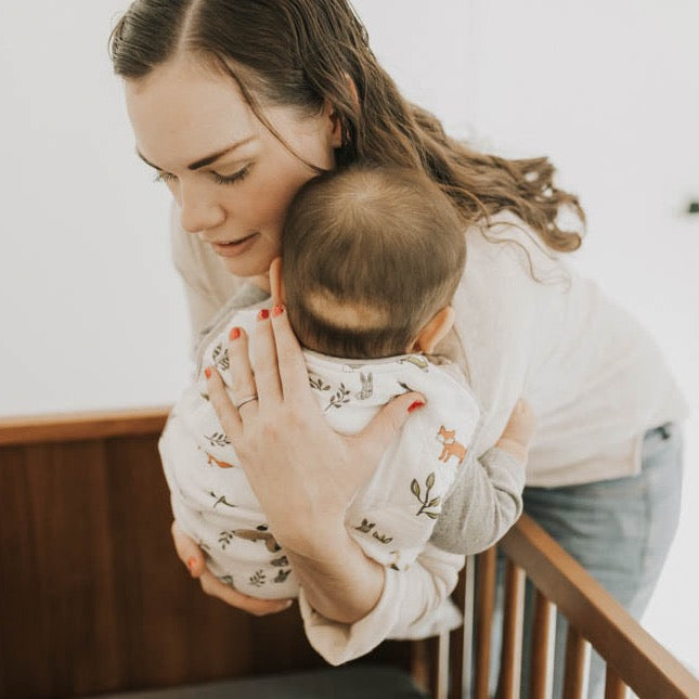 Little Unicorn Cotton Muslin Sleep Bag - Forest Friends styled in nursery, offering soft and safe sleep bags for babies.