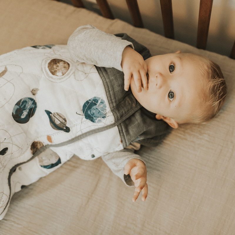 Little Unicorn Cotton Muslin Quilted Sleep Bag - Planetary displayed with celestial pattern, breathable sleep bags for babies.