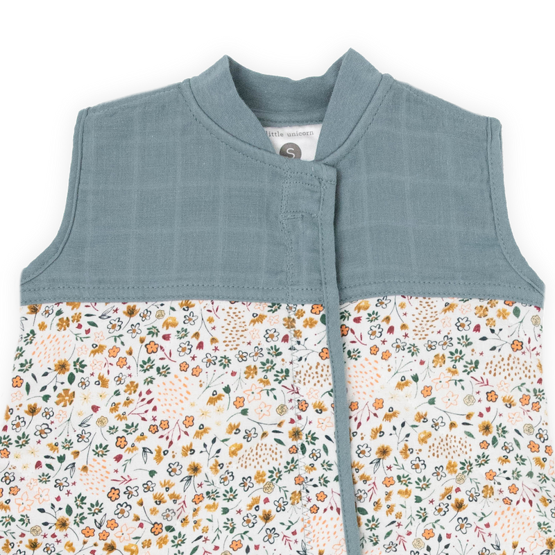 Close-up of Little Unicorn Cotton Muslin Quilted Sleep Bag - Pressed Petals, breathable fabric perfect as a baby sleeping bag.