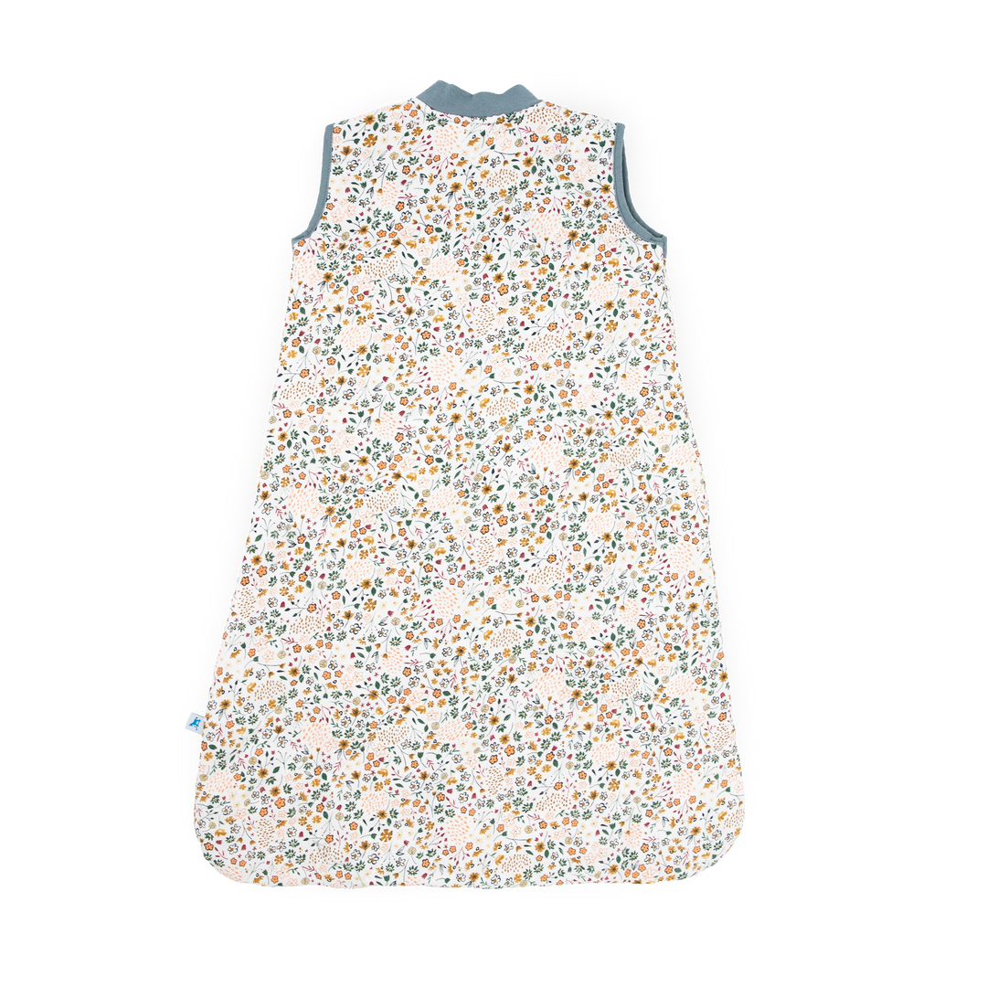 Flat lay of Little Unicorn Cotton Muslin Quilted Sleep Bag - Pressed Petals, lightweight and comfortable baby sleeping bags.