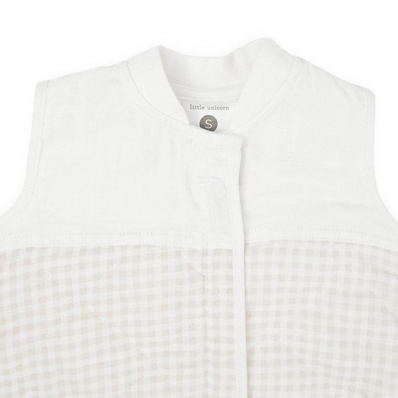 Close-up of Little Unicorn Cotton Muslin Quilted Sleep Bag - Tan Gingham, breathable fabric perfect as a baby sleeping bag.