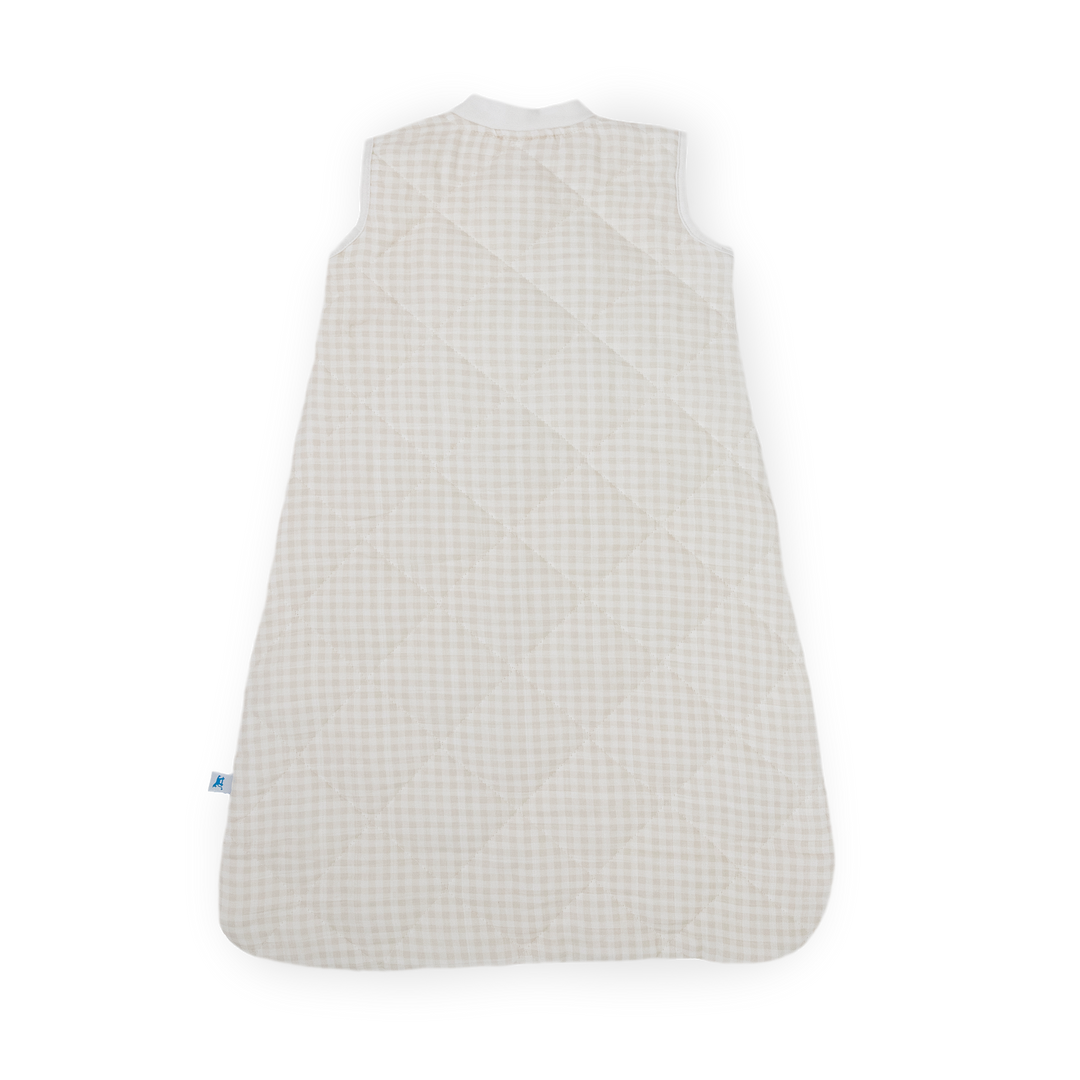 Flat lay of Little Unicorn Cotton Muslin Quilted Sleep Bag - Tan Gingham, lightweight and comfortable baby sleeping bags.