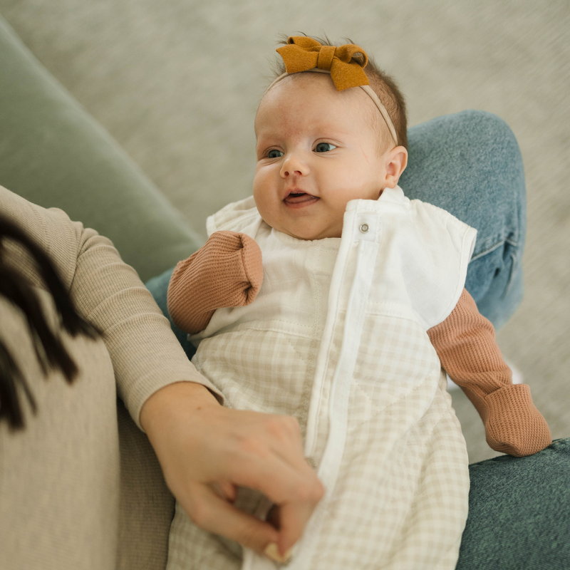 Detail of Little Unicorn Cotton Muslin Quilted Sleep Bag - Tan Gingham, soft quilted muslin fabric as a gentle baby sleep bag.