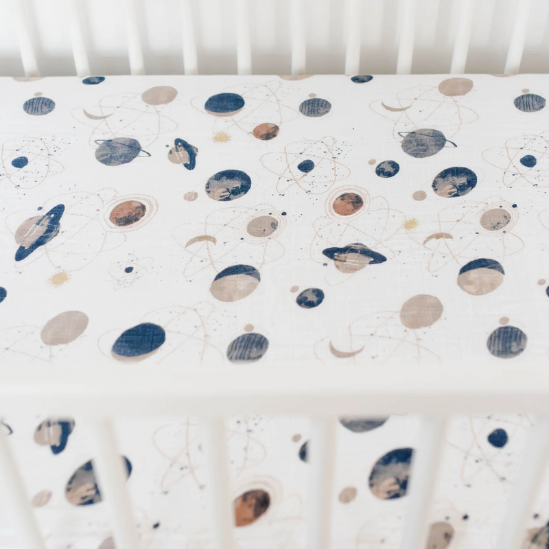 Close-up of Little Unicorn Cotton Muslin Crib Sheet - Planetary showing galaxy details, perfect organic cotton crib sheets.