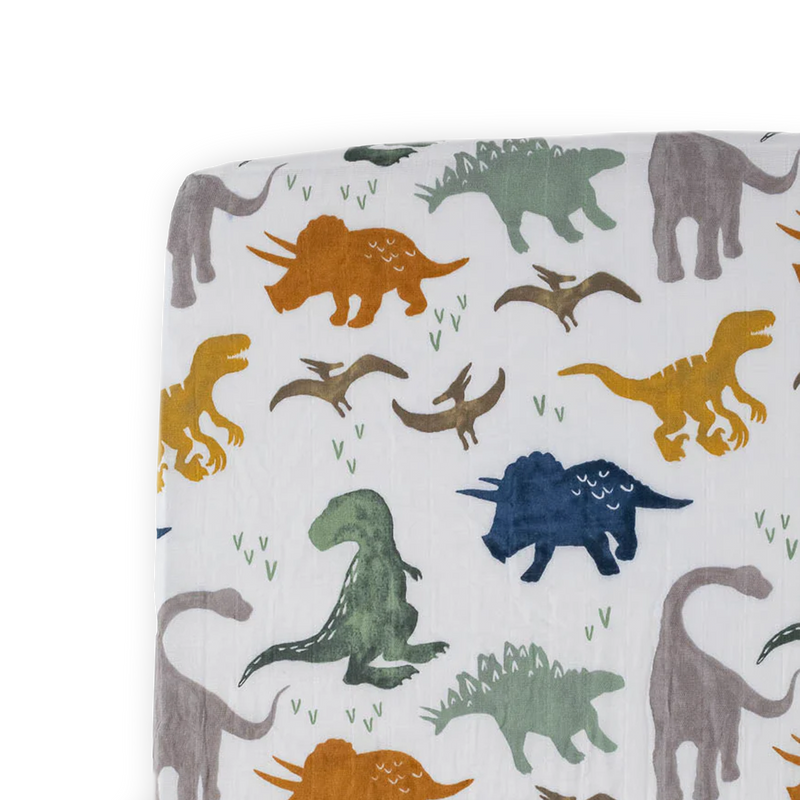 Little Unicorn Cotton Muslin Crib Sheet - Dino Friends brings playful dinosaurs to life with soft and breathable muslin crib sheets.