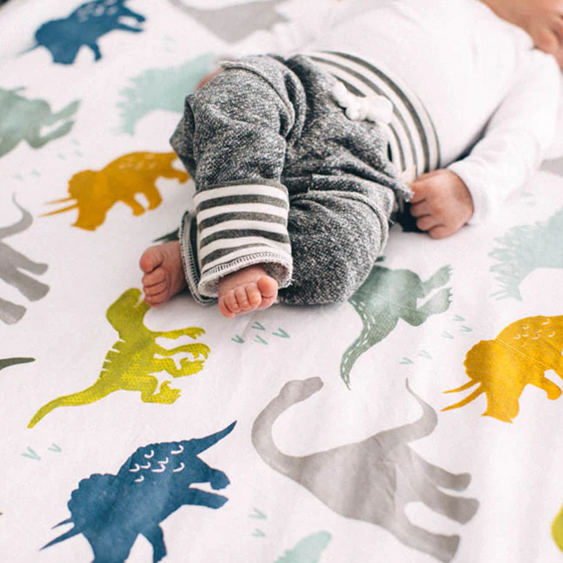 Vibrant and soft, the Little Unicorn Cotton Muslin Crib Sheet - Dino Friends delivers high-quality baby crib sheets for everyday comfort.