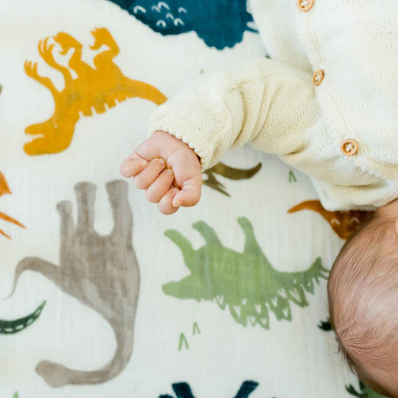 The Little Unicorn Cotton Muslin Crib Sheet - Dino Friends offers playful patterns and gentle cotton sheet for crib time.