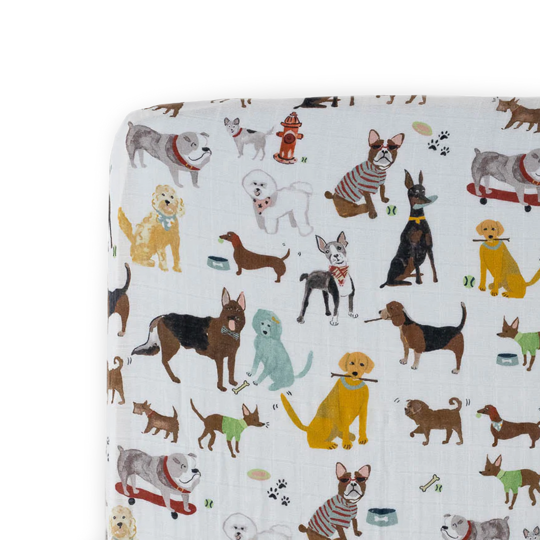 Little Unicorn Cotton Muslin Crib Sheet - Woof displayed folded neatly, soft and breathable muslin crib sheets for everyday comfort.