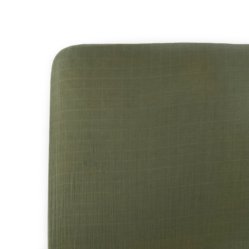 Little Unicorn Cotton Muslin Crib Sheet - Fern neatly folded, breathable muslin design for cozy baby crib sheets.