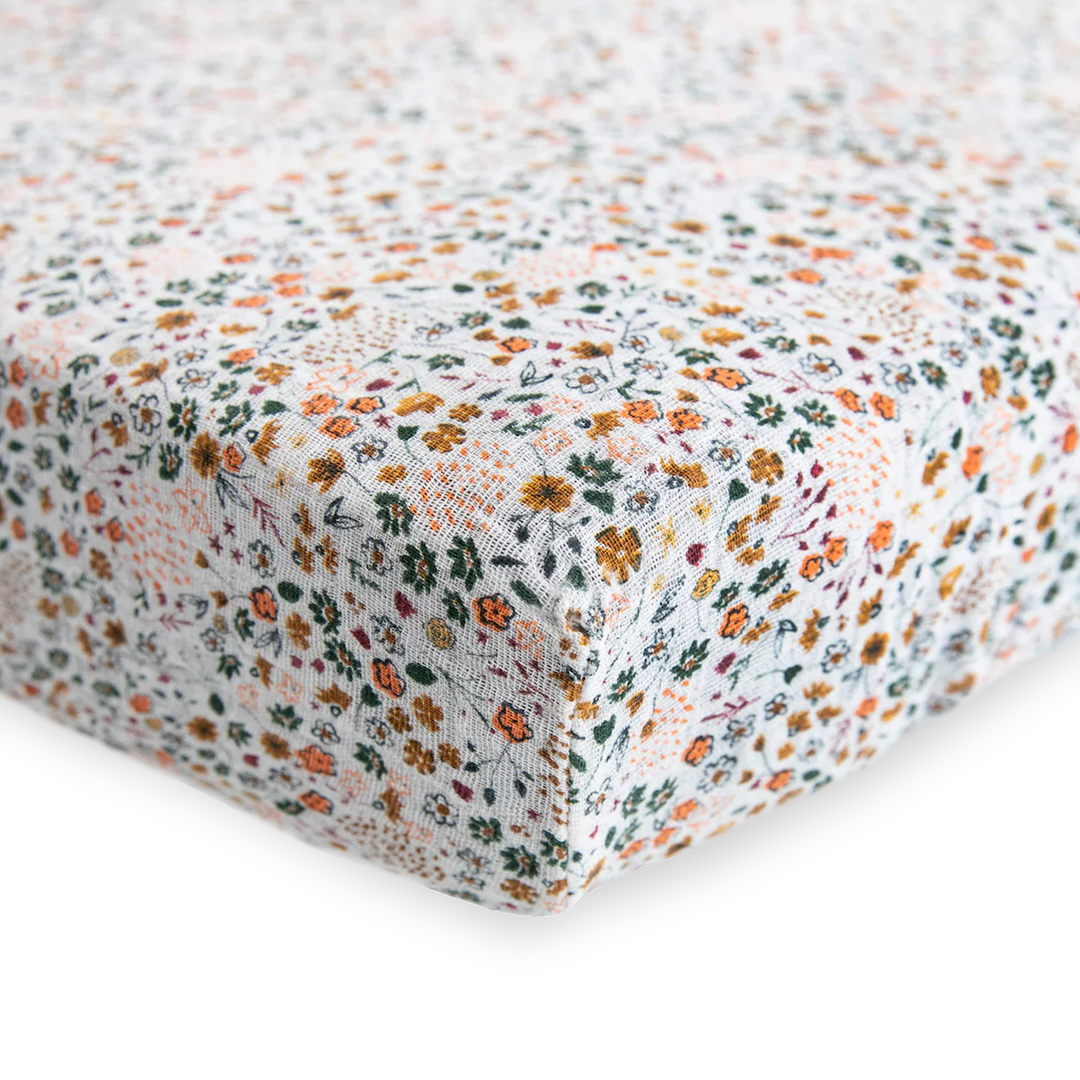 Close-up of Little Unicorn Cotton Muslin Crib Sheet - Pressed Petals showing delicate flower print, perfect organic crib sheet.