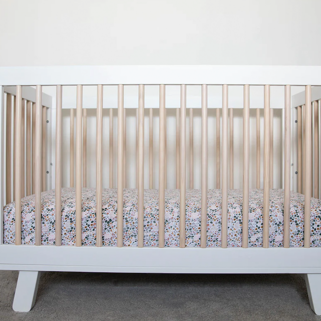 Little Unicorn Cotton Muslin Crib Sheet - Pressed Petals flat lay highlighting texture, cozy and stylish crib mattress sheets.
