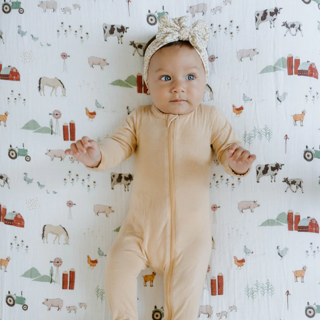 Farm-themed Little Unicorn Cotton Muslin Crib Sheet - Farmyard adds fun to nursery décor, premium cotton crib sheets.