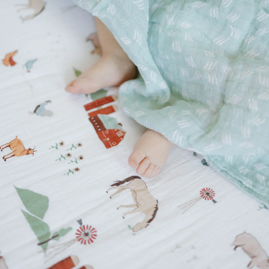 Colorful barnyard animals pattern on Little Unicorn Cotton Muslin Crib Sheet - Farmyard, best crib sheets for little ones.