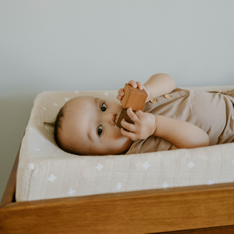 Soft and stylish Little Unicorn Cotton Muslin diaper changing pad in Taupe Cros