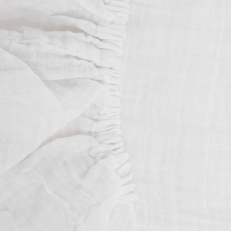 Little Unicorn White Organic Cotton Muslin Crib Sheet styled on crib, one of the best crib sheets for newborns