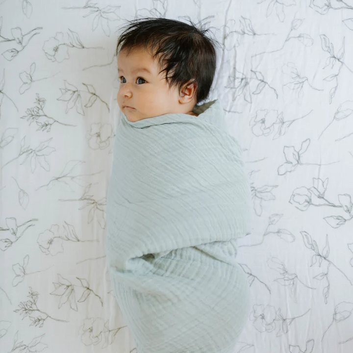 Little Unicorn Pencil Floral Organic Cotton Muslin Crib Sheet styled on crib, premium organic crib sheets for everyday comfort