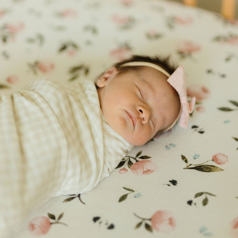 Little Unicorn Stretch Knit Crib Sheet - Watercolor Rose styled with floral accents, ideal for elegant baby crib sheets.