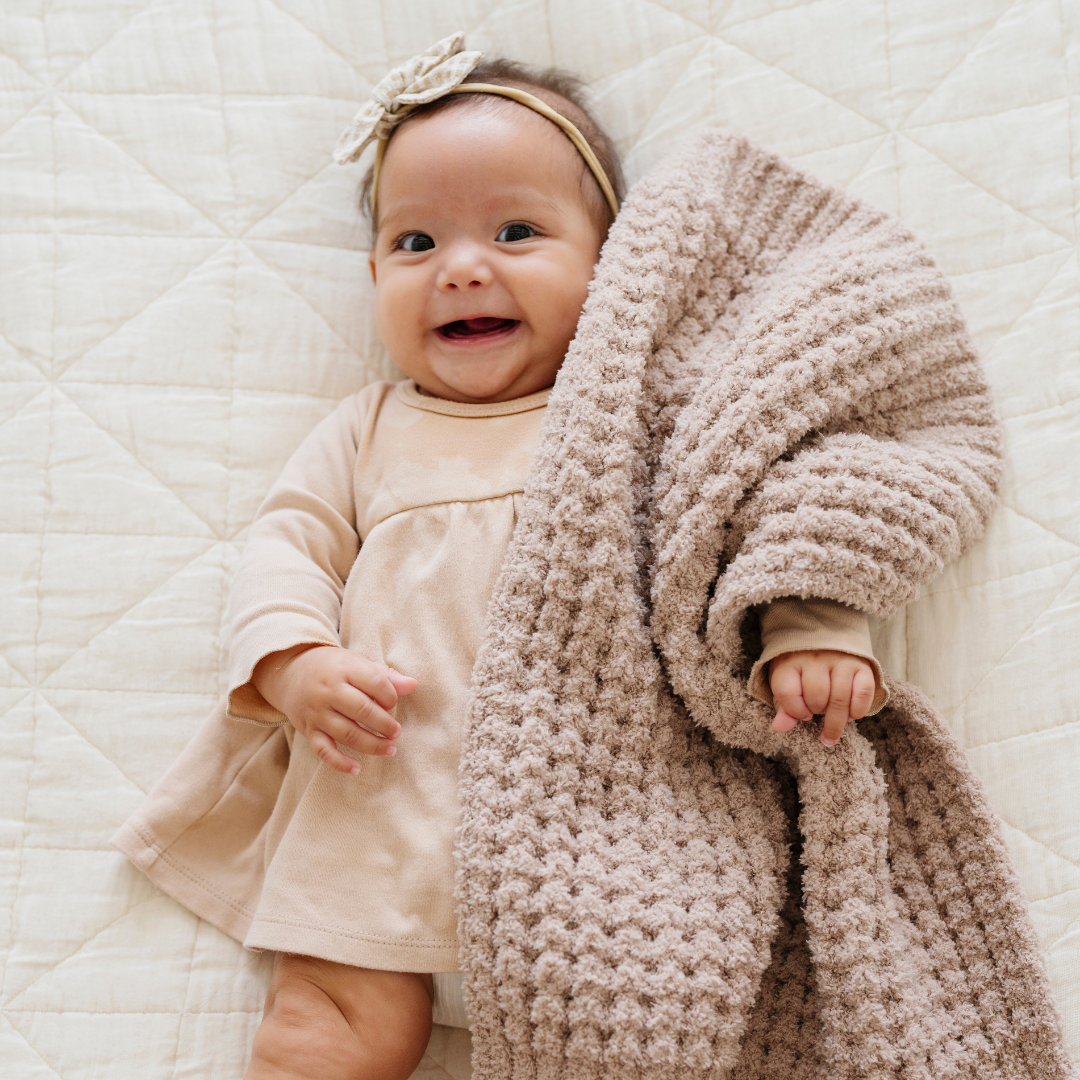Wheat by Saranoni in the Waffle Knit Mini Blanket is plush, minimal, and ultra cuddle friendly as a Baby blanket.
