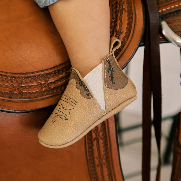 Freshly Picked Cowboy Chelsea Boot baby shoes on foot close-up, comfy soft sole