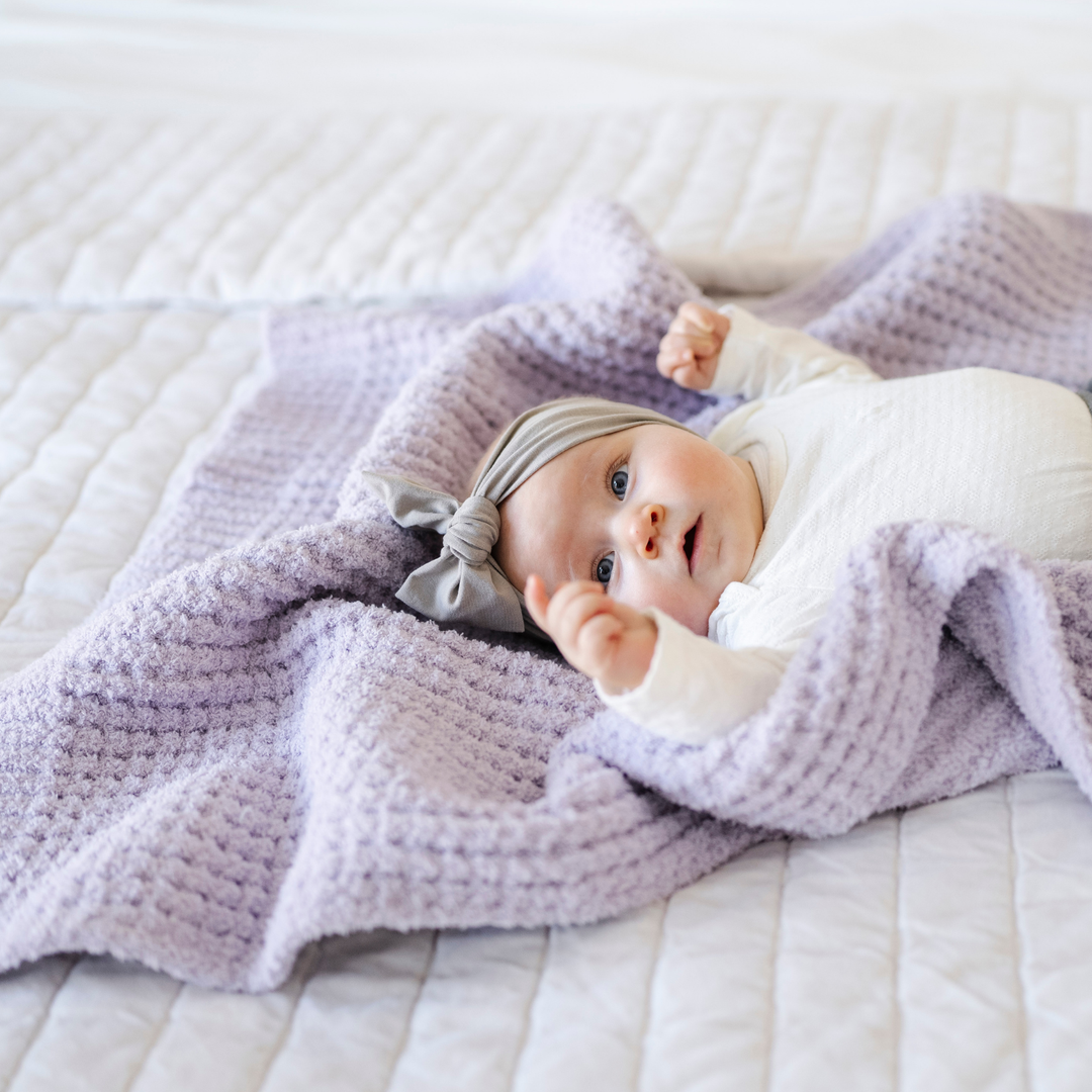 The Wisteria Saranoni Waffle Knit Receiving Blanket is a soft baby blanket perfect for nursery essentials.