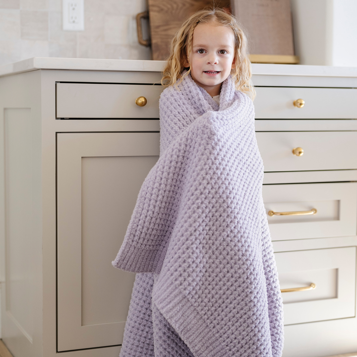 In Wisteria, SaranoniÕs Waffle Knit Toddler Blanket wraps your toddler in unmatched softness and comfort.