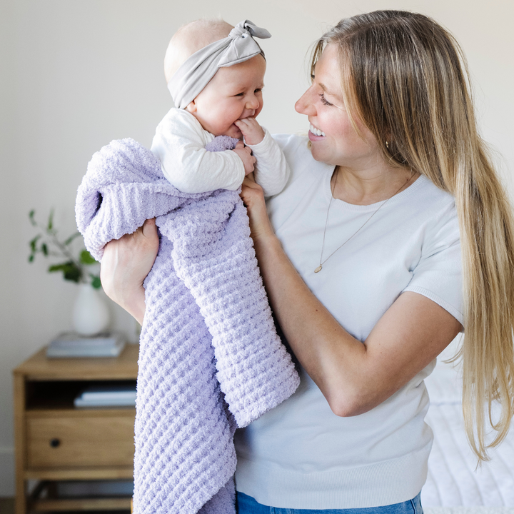 The Saranoni Waffle Knit Toddler Blanket in Wisteria feels cozy and elegant, one of the best toddler blankets.