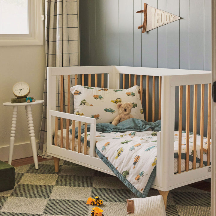 Nursery display featuring Little Unicorn Cotton Muslin Toddler Bedding 3 Piece Set - Work Trucks, vibrant baby bedding set.